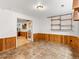 Basement space with wood paneling and tile floors, featuring a partial french door at 1836 S Kendall Ct, Lakewood, CO 80232