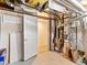 Unfinished basement with mechanicals, exposed ductwork, and a walk-in storage room at 1836 S Kendall Ct, Lakewood, CO 80232