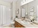 Clean bathroom featuring a shower-tub combo and a vanity with floral accents, offering a functional and stylish design at 1836 S Kendall Ct, Lakewood, CO 80232