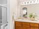 Well-lit bathroom featuring a walk-in shower, a stylish vanity, and fresh decor for a clean and comfortable feel at 1836 S Kendall Ct, Lakewood, CO 80232