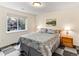 Bedroom with large window and scenic view, featuring a comfortable bed and wood furniture at 1836 S Kendall Ct, Lakewood, CO 80232