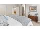 Comfortable bedroom with ensuite bathroom and walk in closet, with a tranquil view of the home at 1836 S Kendall Ct, Lakewood, CO 80232