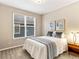 Cozy bedroom with a full bed, window, and soft lighting, creating a peaceful and inviting atmosphere at 1836 S Kendall Ct, Lakewood, CO 80232