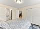 Spacious bedroom featuring an ensuite bath, closet, and serene views from the open door at 1836 S Kendall Ct, Lakewood, CO 80232