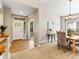 Welcoming foyer flows into dining room and features tile floors and a view of dining space at 1836 S Kendall Ct, Lakewood, CO 80232
