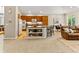 Spacious kitchen featuring wood cabinets, stainless steel appliances, and a central island with bar seating at 1836 S Kendall Ct, Lakewood, CO 80232