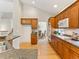 Well-appointed kitchen featuring oak cabinetry, stainless appliances, and granite countertops at 1836 S Kendall Ct, Lakewood, CO 80232