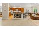 Modern kitchen with bar seating, an island, stainless appliances and open access to the living room at 1836 S Kendall Ct, Lakewood, CO 80232