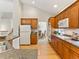 Well-equipped kitchen with wood cabinets, modern appliances, and seamless flow to dining area at 1836 S Kendall Ct, Lakewood, CO 80232