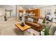 Cozy living room connecting the kitchen, dining, and seating areas in an open-concept design with warm tones at 1836 S Kendall Ct, Lakewood, CO 80232