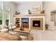 Bright living room with fireplace, built-ins, and comfortable seating arrangement flooded with natural light at 1836 S Kendall Ct, Lakewood, CO 80232