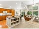 Open-concept living room showcasing hardwood floors, a central island, and a comfortable seating area with vaulted ceilings at 1836 S Kendall Ct, Lakewood, CO 80232
