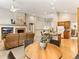 Open-concept design with living room, kitchen, dining, and fireplace, with multiple seating options and bright open space at 1836 S Kendall Ct, Lakewood, CO 80232