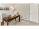 Well-lit home office with a modern desk, decor, and comfortable seating with view of the door at 1836 S Kendall Ct, Lakewood, CO 80232