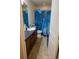 Clean bathroom with a vanity, toilet, and shower with a blue curtain at 12714 Leyden St # C, Thornton, CO 80602