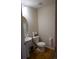 Stylish powder room with a pedestal sink, updated fixtures, and wood-look flooring at 12714 Leyden St # C, Thornton, CO 80602