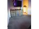 Relaxing bedroom featuring soft carpet, dresser with storage, and a view into the adjacent room at 12714 Leyden St # C, Thornton, CO 80602