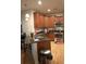 Charming kitchen featuring wooden cabinetry, granite counters, and modern appliances at 12714 Leyden St # C, Thornton, CO 80602