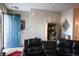 Inviting living room with hardwood floors, a cozy sectional, and ample natural light at 12714 Leyden St # C, Thornton, CO 80602