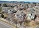 A high angle aerial showcases a charming neighborhood nestled beneath a picturesque mountain range at 7036 Orion Ln, Arvada, CO 80007