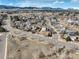 Wide aerial view of the neighborhood featuring rolling hills and scenic beauty at 7036 Orion Ln, Arvada, CO 80007