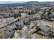 Wide aerial view of the neighborhood with mountain backdrop at 7036 Orion Ln, Arvada, CO 80007