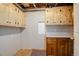 An unfinished basement room has wooden cabinets at 7036 Orion Ln, Arvada, CO 80007