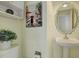 Charming half bathroom with a decorative mirror and pedestal sink at 7036 Orion Ln, Arvada, CO 80007