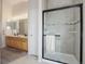 Beautiful bathroom featuring double sinks, ample counter space, and a tile surround shower at 7036 Orion Ln, Arvada, CO 80007