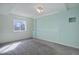 Bright bedroom featuring a large window and neutral carpeting, offering a comfortable and serene living space at 7036 Orion Ln, Arvada, CO 80007