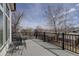 Outdoor deck area with metal railing and furniture, perfect for relaxing at 7036 Orion Ln, Arvada, CO 80007