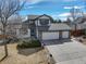 Charming two-story home featuring a three car garage and well maintained front yard and stone accents at 7036 Orion Ln, Arvada, CO 80007