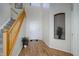 Bright foyer featuring hardwood floors, a staircase, and a soaring two-story ceiling at 7036 Orion Ln, Arvada, CO 80007