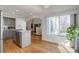 Kitchen view with a large island and stainless steel appliances and hardwood floors at 7036 Orion Ln, Arvada, CO 80007