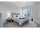 Bright main bedroom with a large window and decorative headboard at 7036 Orion Ln, Arvada, CO 80007