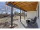 Covered patio with seating area provides an inviting outdoor space with a backyard view at 7036 Orion Ln, Arvada, CO 80007