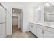 Bathroom featuring double sink vanity, walk-in closet and shower with glass door at 27554 E Byers Ave, Aurora, CO 80018