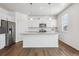 Modern kitchen features white cabinetry, granite countertops, and stainless steel appliances at 27554 E Byers Ave, Aurora, CO 80018