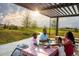 Gathering enjoys a picnic lunch under a shade structure with prairie views at 27554 E Byers Ave, Aurora, CO 80018