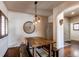 Bright dining room features a rustic wooden table with benches, a unique light fixture, and an accent wall at 23760 Eagle Bend Ln, Parker, CO 80138