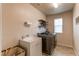 Laundry room with washer, dryer, and shelving at 23760 Eagle Bend Ln, Parker, CO 80138