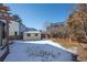 A snowy backyard with a storage shed and partially covered ground at 10407 Strasburg Way, Parker, CO 80134