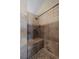 Tiled shower featuring stone tile accents, seating, and a modern shower head at 10407 Strasburg Way, Parker, CO 80134
