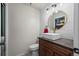Modern bathroom with vessel sink, wood vanity, gold fixtures, and new lighting at 10407 Strasburg Way, Parker, CO 80134