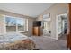 Carpeted bedroom boasts a window seat, natural light, and a warm color palette at 10407 Strasburg Way, Parker, CO 80134