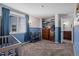 Bright Bedroom featuring a crib, large window, and adjacent bathroom at 10407 Strasburg Way, Parker, CO 80134