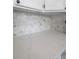 Close-up of kitchen with marble countertops and modern backsplash at 10407 Strasburg Way, Parker, CO 80134