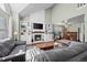 Well-lit living room featuring a fireplace, built-in shelving, and plenty of seating at 10407 Strasburg Way, Parker, CO 80134
