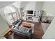 Open-concept living room with fireplace, large windows, and hardwood floors at 10407 Strasburg Way, Parker, CO 80134