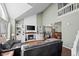 Bright living room with vaulted ceilings, fireplace, and built-in shelving units at 10407 Strasburg Way, Parker, CO 80134